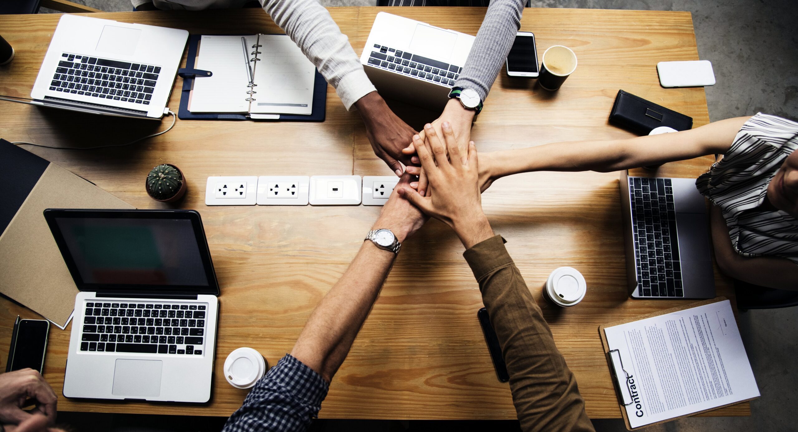 Team of business people stacking hands